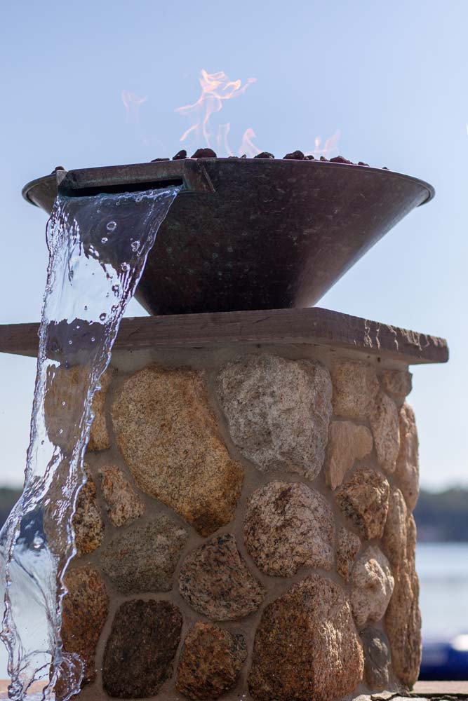 Decorative water streams next to pool