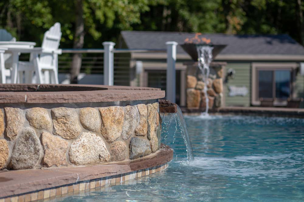 Decorative water streams next to pool