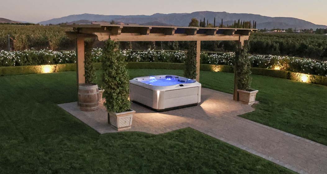 Hot tub in beautiful backyard at night