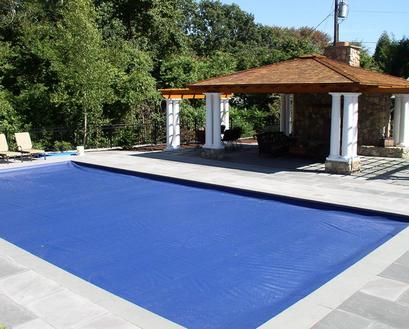 Pool with cover in back yard
