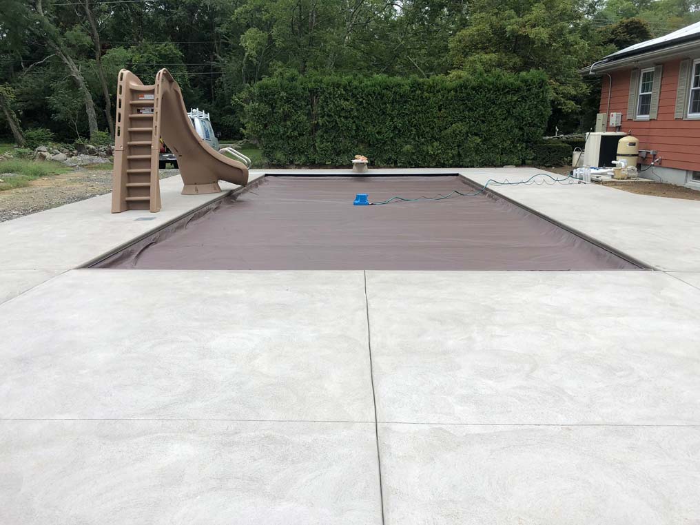 Pool with cover in back yard