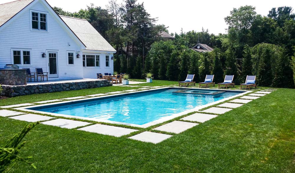 New pool in backyard with chairs