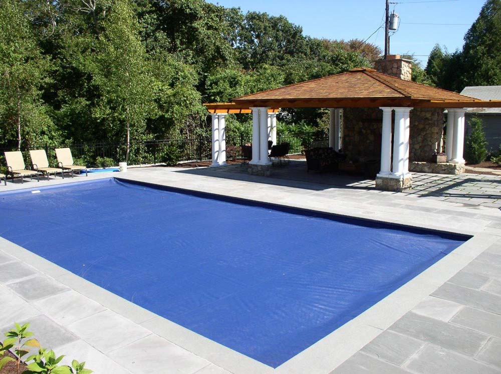 Pool with cover in back yard